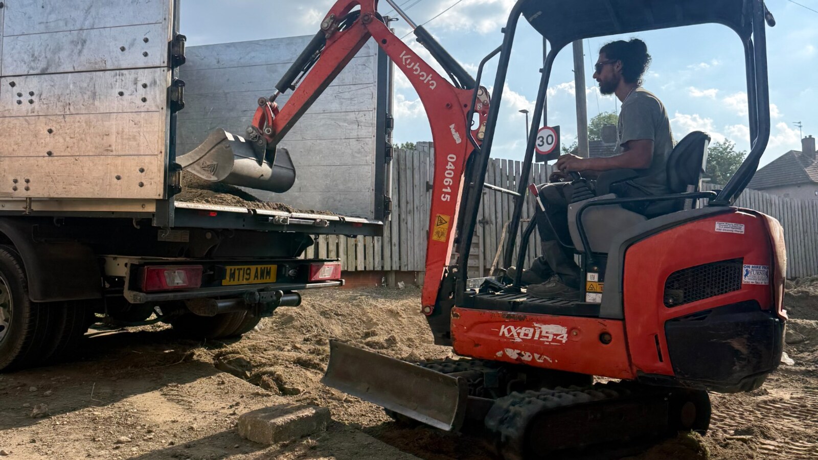 Real PAV Recycle mini digger and operator at work for a Chesterfield service